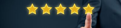 five gold star review with a finger pointing at it