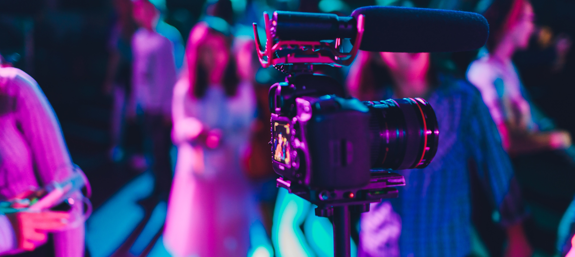 video being filmed at an event with pink blue lighting